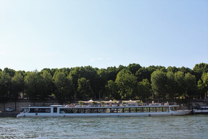 Paris Gourmet Dinner Seine River Cruise with Singer and DJ Set - The Diamant Bleu boat experience: rooftop views and indoor seating